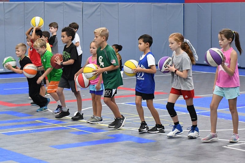 Youth basketball team with coaches in the gym